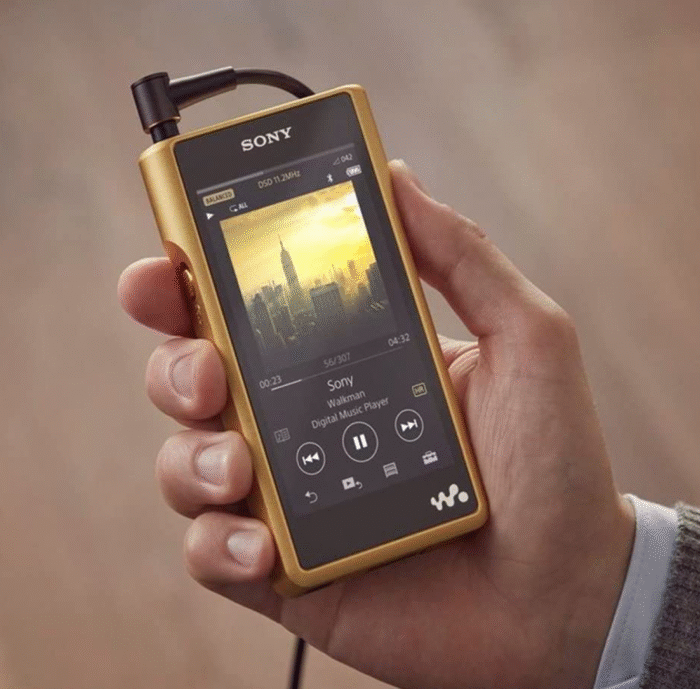 Hand holding a gold Sony Hi-Res Audio Walkman digital music player, displaying an album cover of a city skyline on the screen. Portfolio work by senior copywriter and strategist Paul Baker, who developed content strategy and messaging to introduce Sony’s Hi-Res Audio technology to consumers