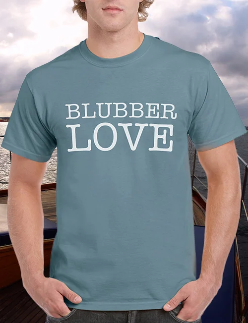 Man wearing a blue T-shirt with the phrase “Blubber Love” printed in bold white letters. Portfolio work by associate creative director and writer Paul Baker for Hornblower Cruises’ proposed “Blubber Club” loyalty program, designed to engage dedicated whale watchers and citizen scientists with exclusive perks and branded merchandise.